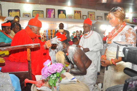 Chief Bright Apinoko receiving chiefaincy crown from HRM Ohworode of Olomu Kingdom