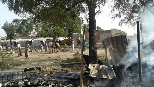 In this image supplied by MSF, smoke rises from a burnt out shelter at a camp for displaced people in Rann, Nigeria, Tuesday Jan. 17, 2017. Relief volunteers are believed to be among the more than 100 dead after a Nigerian Air Force jet fighter mistakenly bombed the refugee camp, while on a mission against Boko Haram extremists. (Medecins Sans Frontieres (MSF) via AP)